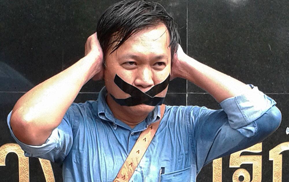 Pravit Rojanaphruk, an outspoken Thai columnist for the English-language daily The Nation, poses for a photograph while being called to report himself to the ruling military along with other journalists in Bangkok, Thailand.