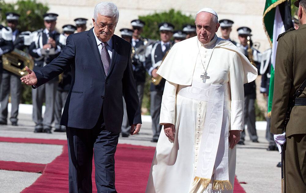 Pope Francis is welcomed by Palestinian President Mahmoud Abbas, left, upon his arrival to the West Bank city of Bethlehem.