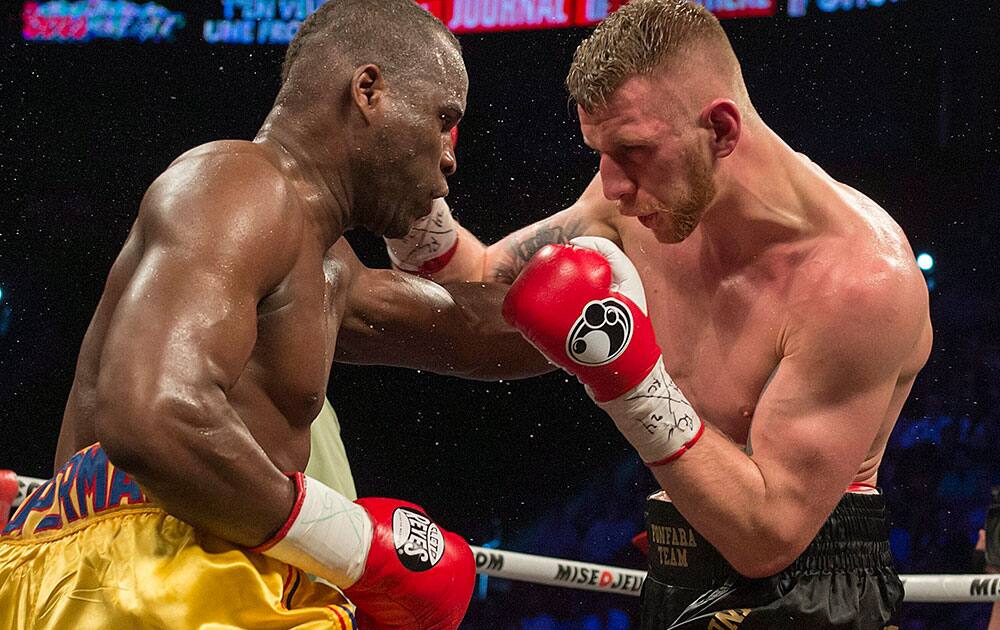 Adonis Stevenson left, and Andrzej Fonfara battle in a WBC light heavyweight title bout in Montreal.