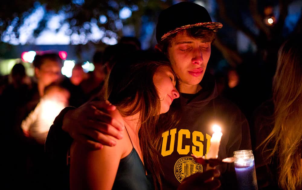 Two students comfort each other during a candlelight vigil held to honor the victims of Friday night`s mass shooting in Isla Vista, Calif.
