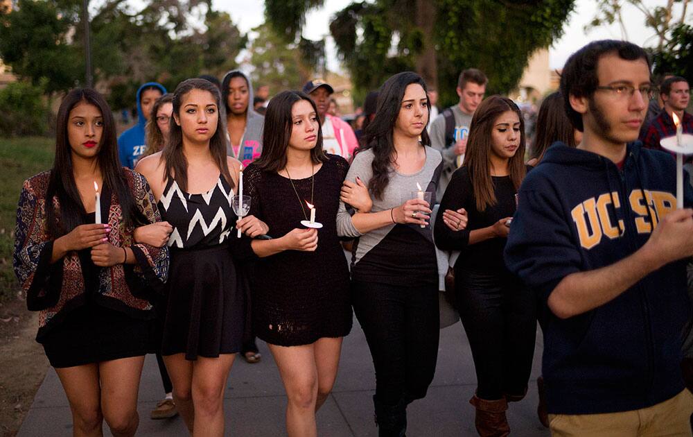 Students march on the campus of the University of California, Santa Barbara during a candlelight vigil held to honor the victims of Friday night`s mass shooting in Isla Vista, Calif.