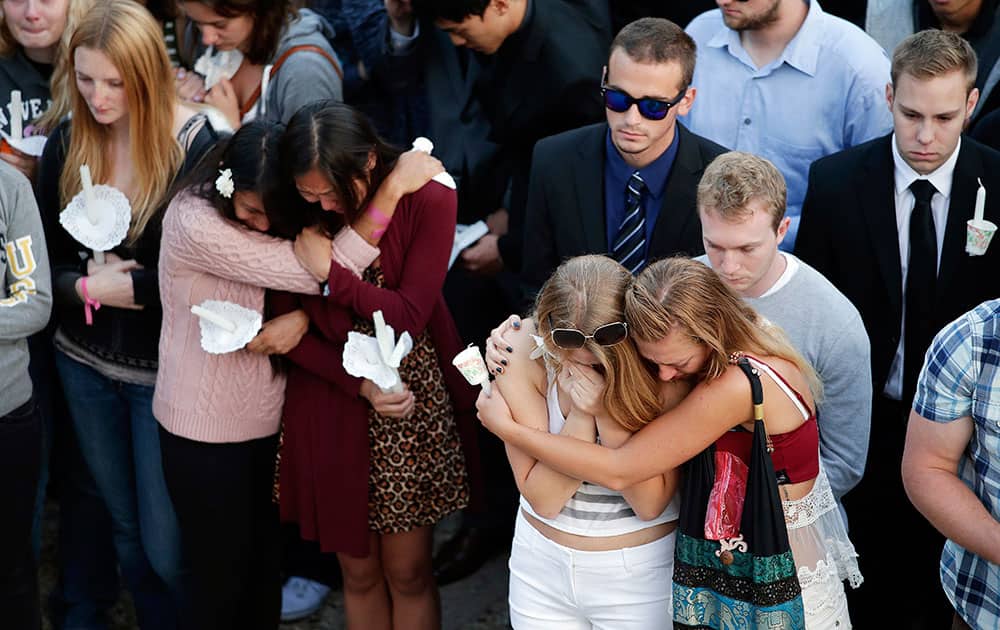 Students comfort each other during a candlelight vigil held to honor the victims of Friday night`s mass shooting on the campus of the University of California, Santa Barbara.
