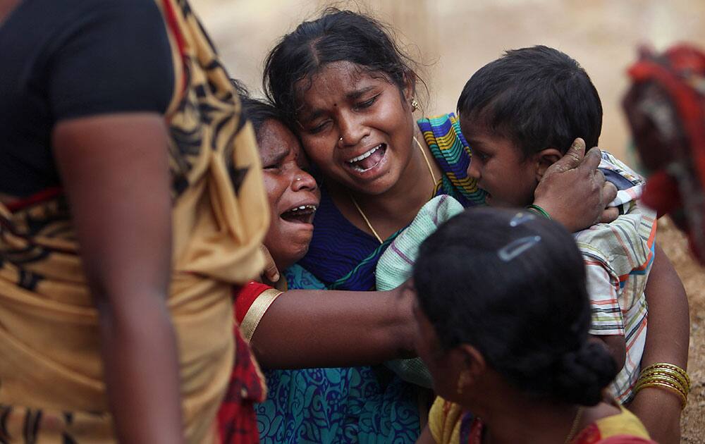 Unidentified Indian women mourn victims of an accident in Hyderabad. Two laborers were killed and one injured when the wall of a building collapsed at a construction site, according to reports