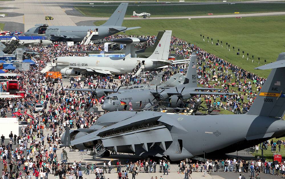 Visitors walk around the exhibition area of the ILA Berlin Air Show 2014 in Selchow, Germany. The aerospace and defence industry exhibition takes place at the southern area of Berlin-Schoenefeld airport until May 25.