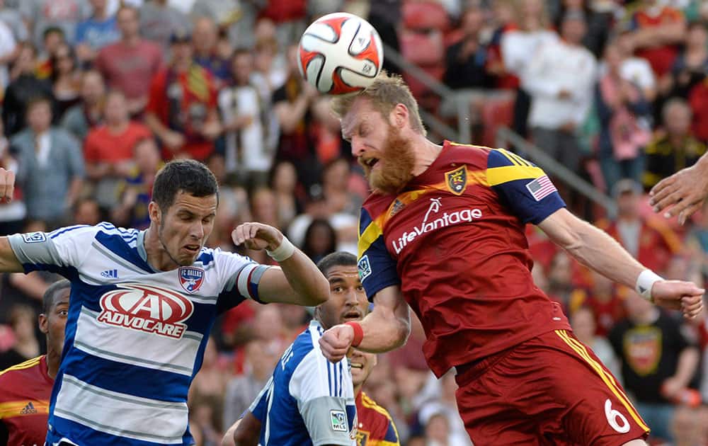 Real Salt Lake defender Nat Borchers (6) connects with the ball, as FC Dallas defender Matt Hedges closes in during an MLS soccer game in Sandy, Utah.