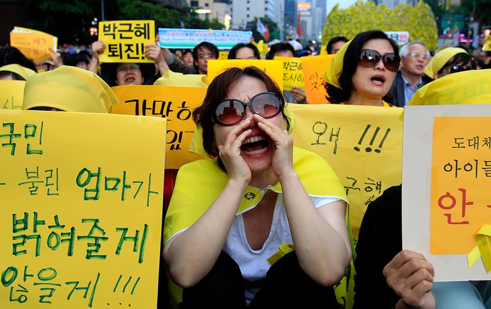 A woman shouts names of victims during a rally to demand the government to seek the truth in poor handling of the sinking of the ferry Sewol, in Seoul, South Korea.