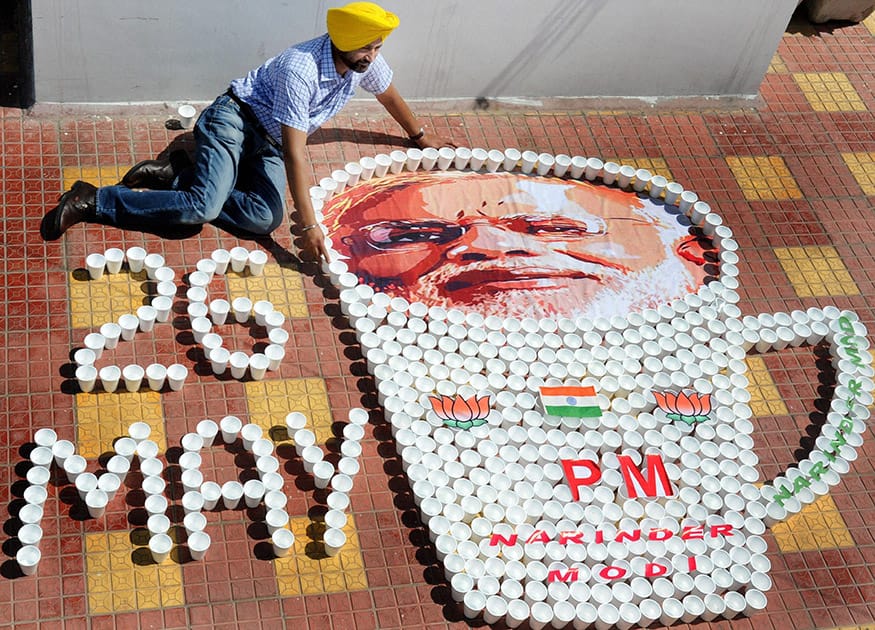 A miniature artist creates a picture of Prime Minister-designate Narendra Modi with glasses used for serving tea to congratulate him ahead of his swearing-in ceremony, in Amritsar.