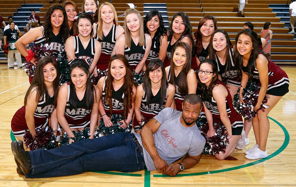 During his Chicago stop of the Old Spice Scent Responsibly tour, the world-famous `Old Spice Guy` Isaiah Mustafa poses with the cheerleaders from Morton West High School, in Berwyn, Illinois, after an assembly to teach students how not to overspray.