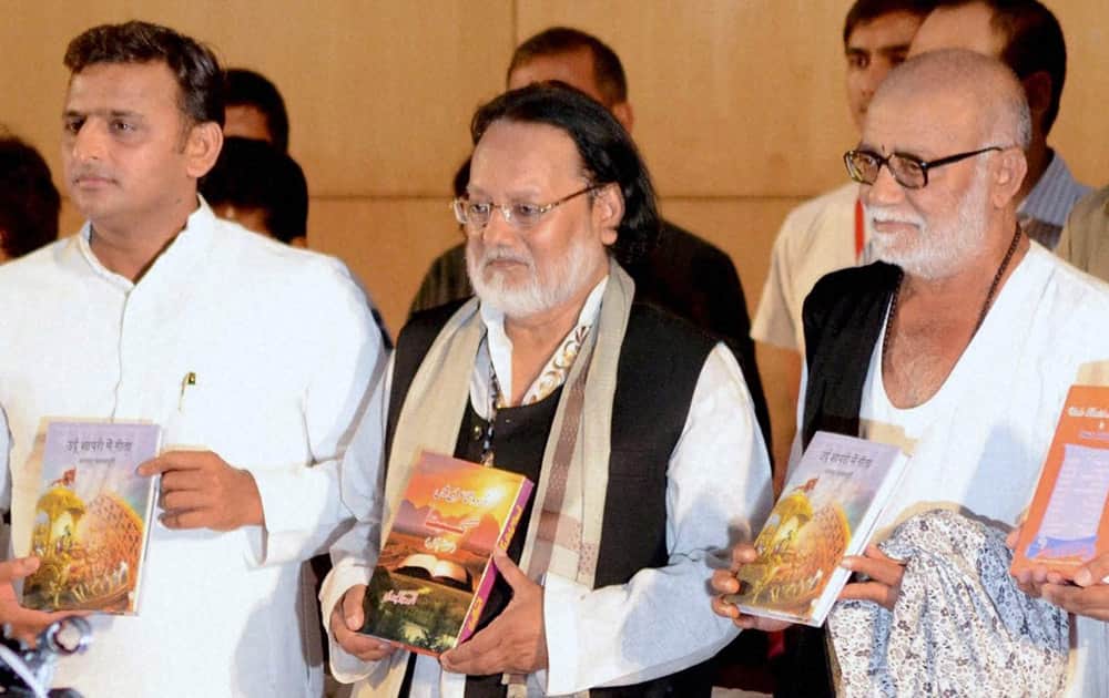 Uttar Pradesh Chief Minister Aklhilesh Yadav with spiritual preacher Morari Bapu (right) and author Anwar Jalalpuri releasing the latter`s book `Urdu Shayari me Geeta` in Lucknow.
