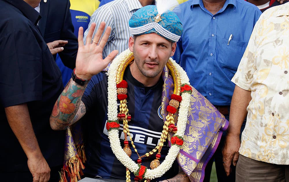 Former Italian footballer and Inter Milan defender Marco Materazzi waves to the crowd after he was honored by officials of the Bangalore Football Stadium in Bangalore.