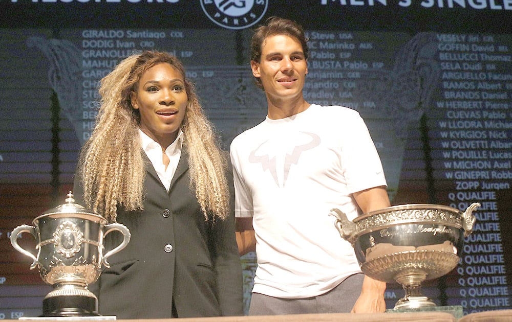 Defending champions Serena Williams, of the U.S, left, and Spain`s Rafael Nadal pose during the draw for the French Open Tennis tournament, at the Roland Garros stadium in Paris.