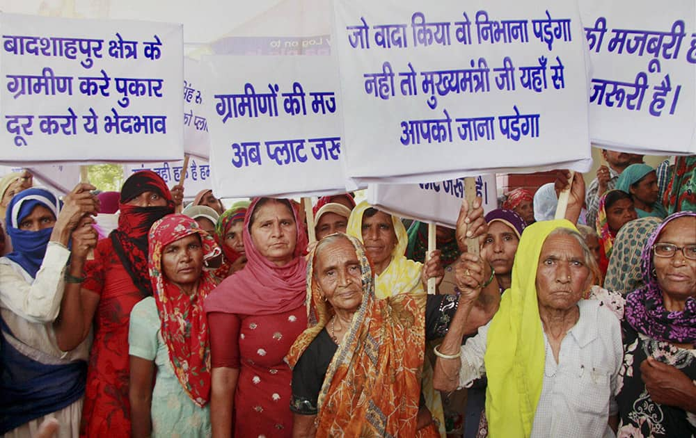 Citizens belonging to Below Poverty Line (BPL) hold a protest outside Gurgaon Deputy Commissioner`s office demanding 100 square plots for them in Gurgaon.