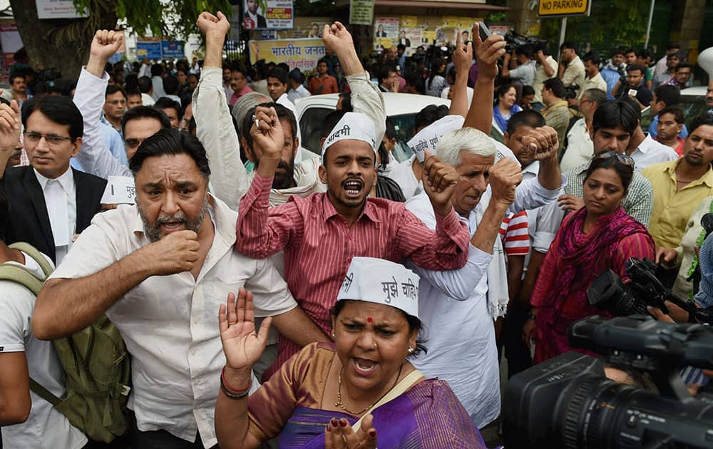 AAP activists protest in support of party chief Arvind Kejriwal outside the Patiala House court in New Delhi.