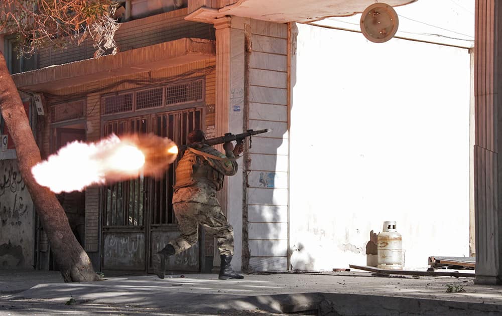 An Afghanistan`s National Army (ANA) soldier fires his weapon at the site of a clash between insurgents and security forces over Indian Consulate in Herat, Afghanistan.