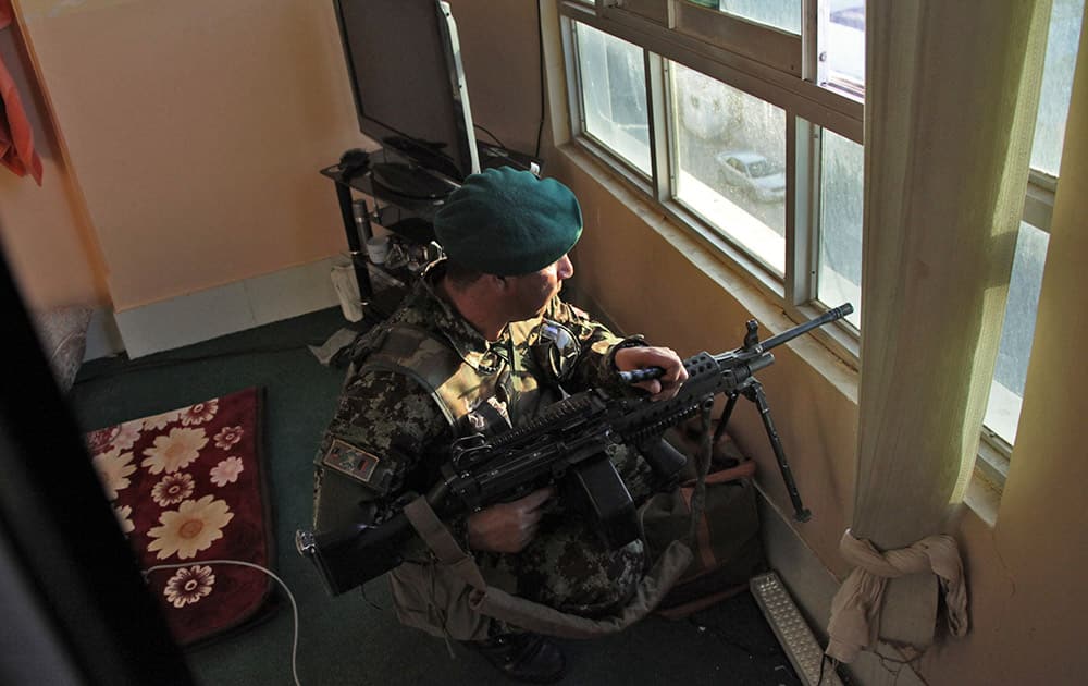 An Afghanistan`s National Army (ANA) soldier takes up position near the site of a clash between insurgents and security forces at the Indian Consulate in Herat, Afghanistan.