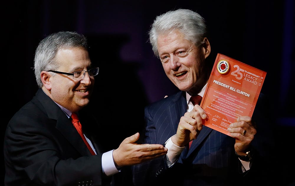 Michael Brown co-founder & CEO of City Year presents former President Bill Clinton the City Year Legacy Award at a Boston Pops Concert Celebrating City Year`s 25th Anniversary at Symphony Hall in Boston.