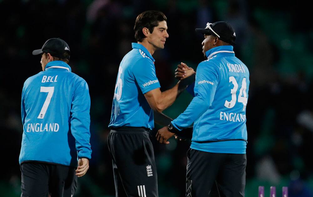 Man of the match England`s Chris Jordan is congratulated by his captain Alastair Cook at the end of the One Day cricket match between England and Sri Lanka at the Oval cricket ground in London. England won by 81 runs.