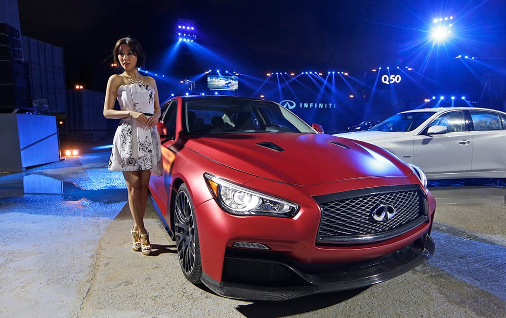 Taiwan actress Annie Liu poses with the new Infiniti Q50 sports sedan during a launching ceremony in Hong Kong.