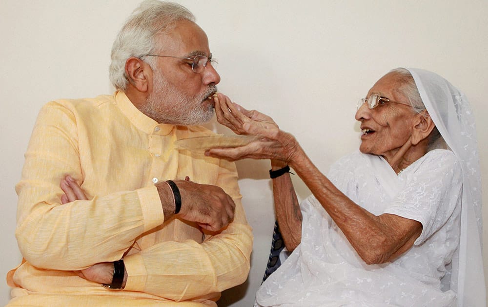 Prime Minister-designate Narendra Modi is offered sweets by his mother Hiraba during a meeting at her residence in Gandhinagar.