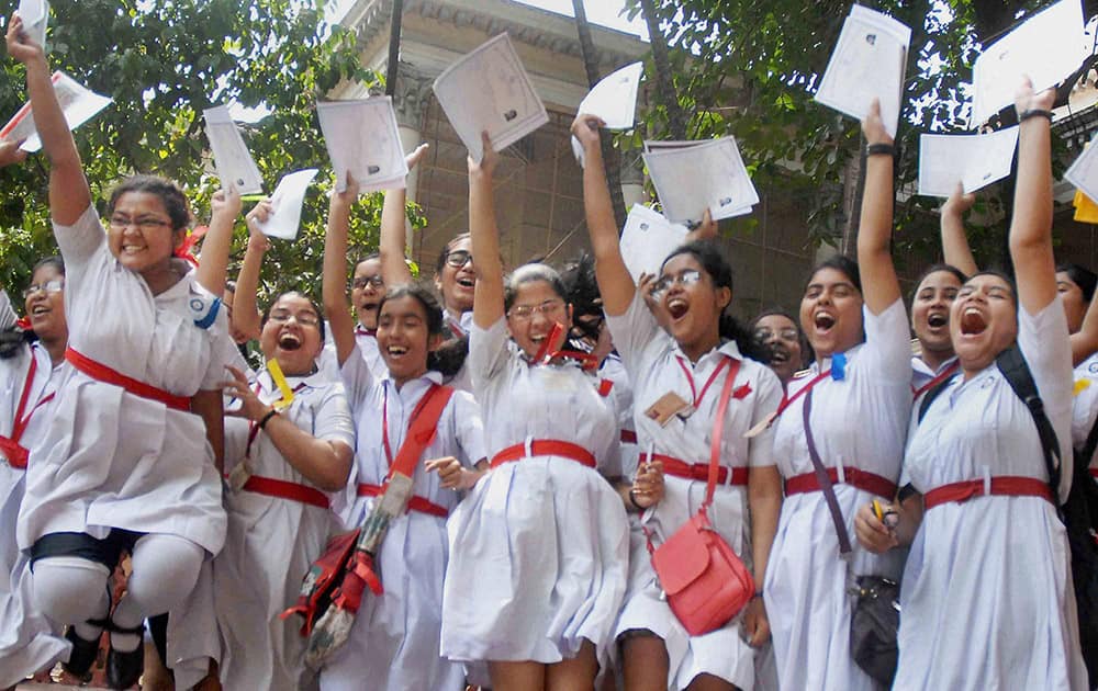 Students celebrate their success in West Bengal Board of Secondary Education at a school in Kolkata.