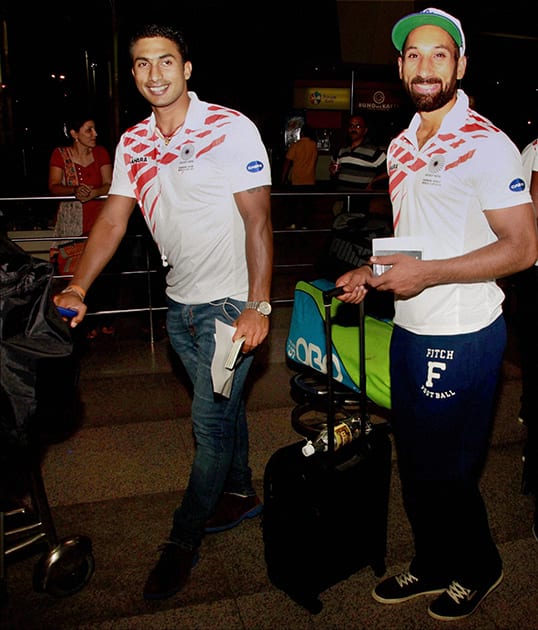 Indian hockey team skipper Sardar Singh with a team mate at the IGI airport in New Delhi on Wednesday night before their departute for the World Cup to be held at The Hague, Netherlands from May 31 to June 15.