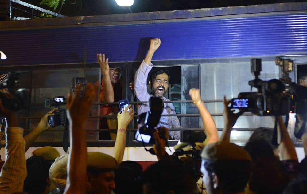 Aam Aadmi Party leader Yogendra Yadav shouts as he taken in police bus during a protest outside Tihar Prisons over the arrest of party chief Arvind Kejriwal in New Delhi.