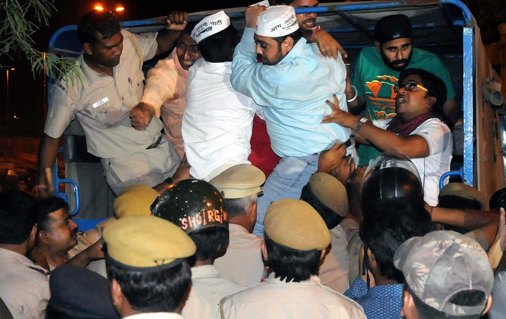 Police in action against AAP supporters who were protesting outside Tihar Prisons over the arrest of party chief Arvind Kejriwal in New Delhi.