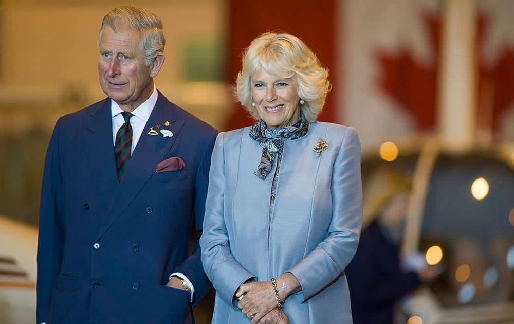 Prince Charles and wife Camilla look on as they stand on stage during an event to mark aerospace and aviation in Manitoba day in Winnipeg.