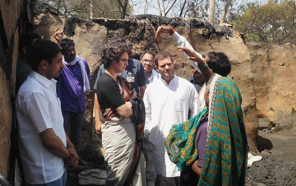 Congress Vice President Rahul Gandhi along with his sister Priyanka Vadra interacting with villagers at the fire-hit Barauliya village in Amethi.