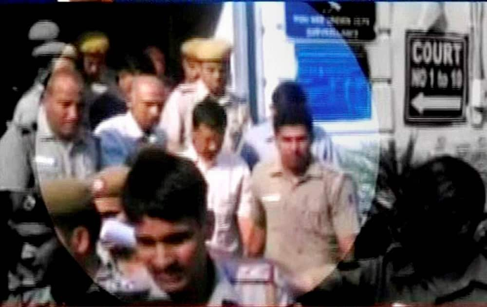 AAP chief Arvind Kejriwal is escorted at Patiala House Courts in New Delhi on Wednesday after a court ordered him to judicial custody for two days in connection with the defamation complaint filed against him by BJP leader Nitin Gadkari.