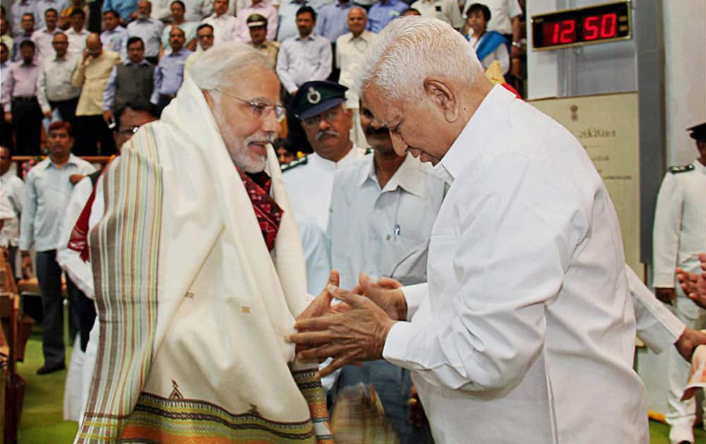 Narendra Modi is greeted by Speaker Vaju Vala during the special session of the state Assembly in Gandhinagar.