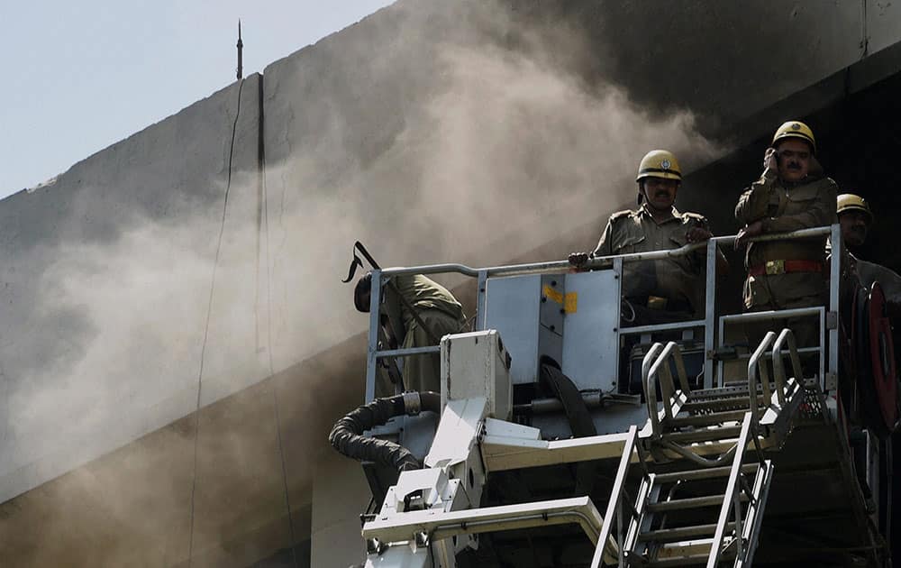 Fire personnel try to douse a minor fire that broke out on the 7th floor of Shastri Bhavan in New Delhi.