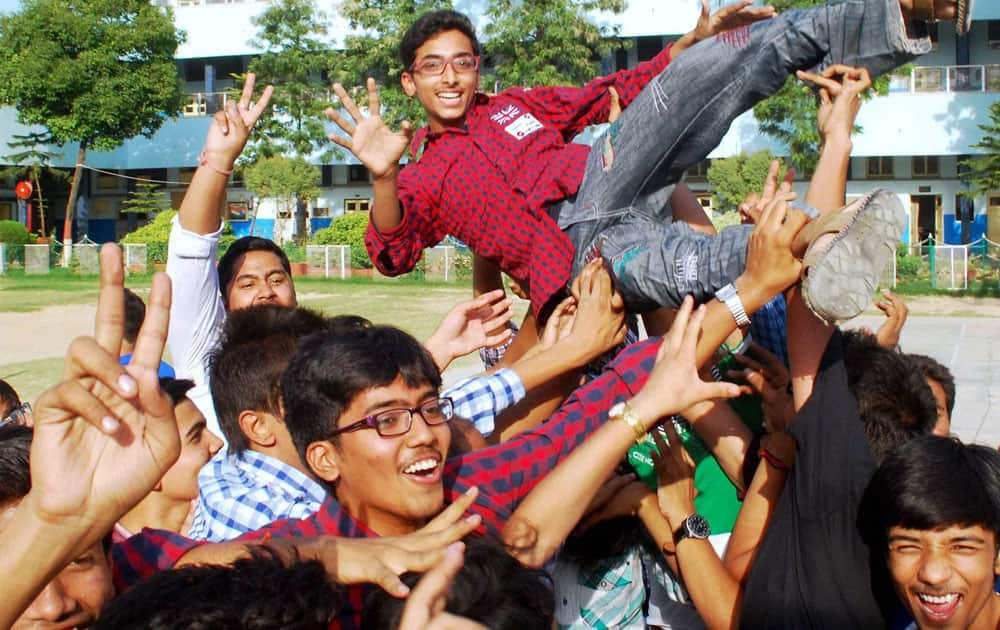 Students celebrate their success after announcement of CBSE class X results at their school in Allahabad.