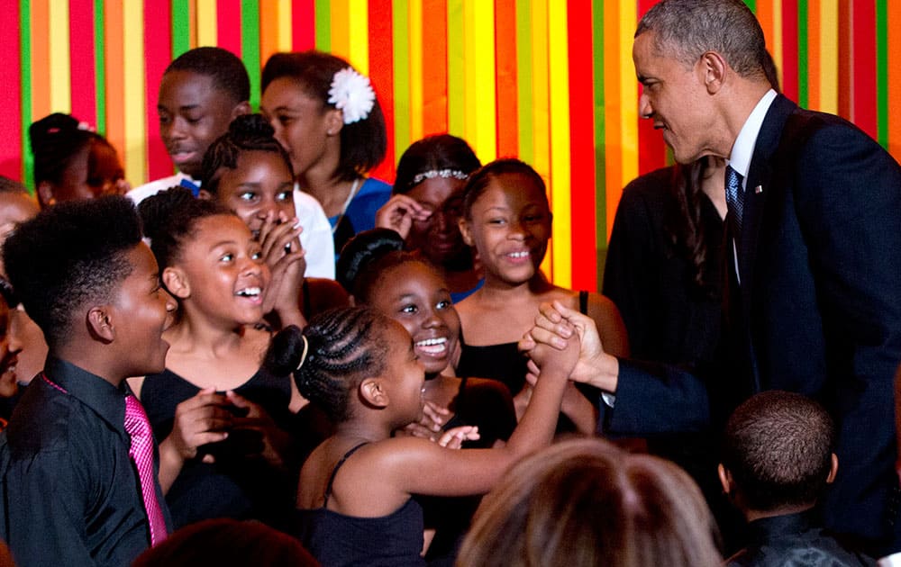 President Barack Obama greets student performers on stage during the White House Talent Show, in the East Room of the White House, in Washington.