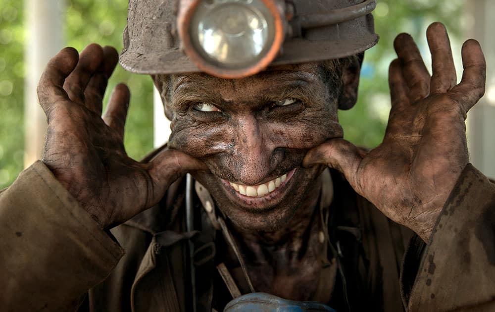 A Ukrainian coal miner smiles, after finishing his shift at a coal mine outside Donetsk, Ukraine.