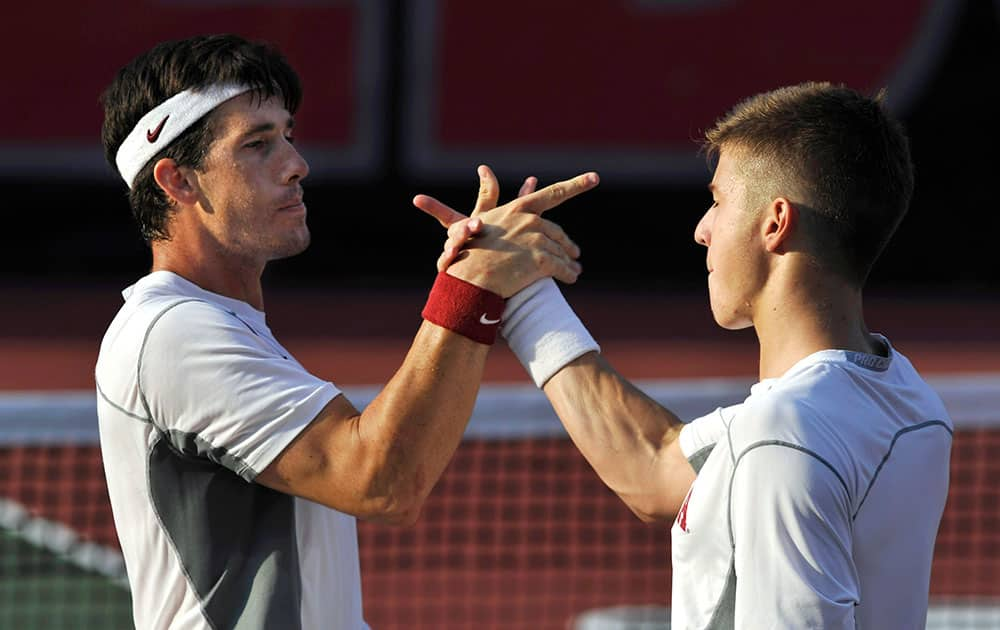 Oklahoma`s Guillermo Alcorta, left, and Andrew Harris celebrate their win over Southern California`s Connor Farren and Roberto Quiroz during a men`s doubles match in the NCAA Division I team tennis championships.