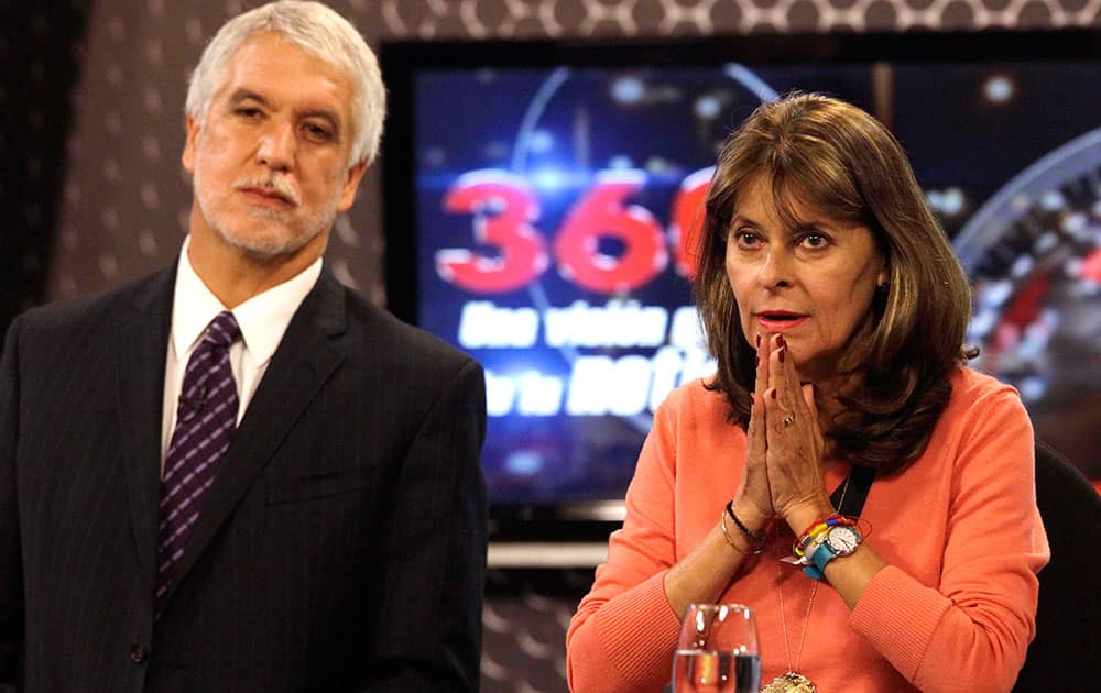 Marta Lucia Ramirez, presidential candidate of the Conservative Party, right, and presidential candidate for the Green Alliance, Enrique Penalosa stand during a televised debate in Bogota,Colombia.