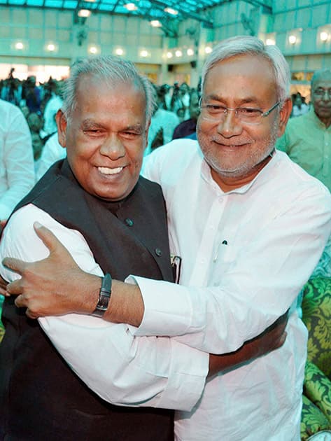 Bihar`s new Chief Minister Jitan Ram Manjhi is greeted by his predecessor Nitish Kumar after he took oath of office and secrecy at Raj Bhawan in Patna.