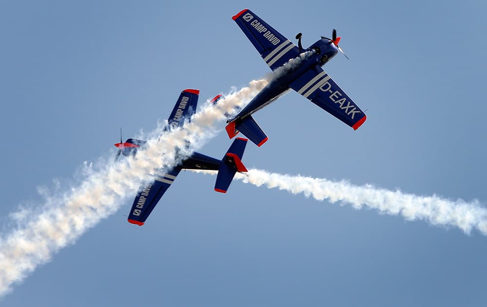 German pilots Walter Eichhorn and his son Toni Eichhorn fly their Extra 300 airplanes during the Berlin Air Show ILA in Berlin, Germany.