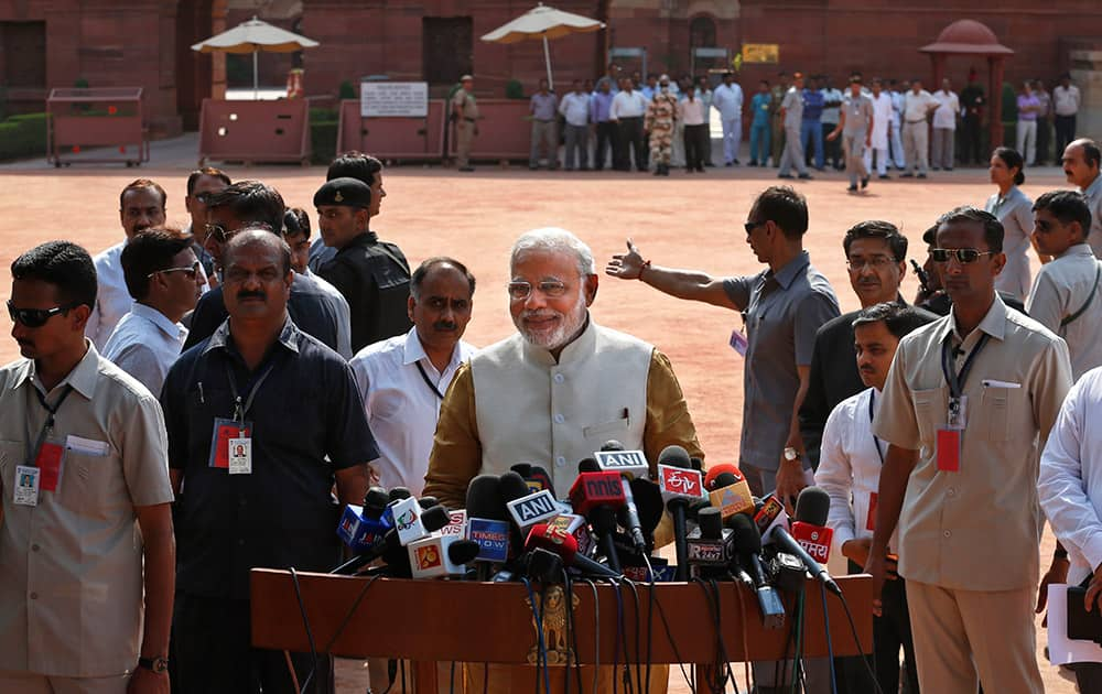 Narendra Modi addresses the media after meeting the Indian President, outside the Presidential Palace in New Delhi.