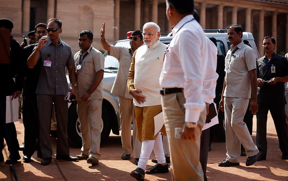 Narendra Modi arrives to address the media after meeting the Indian president, outside the Presidential Palace in New Delhi.