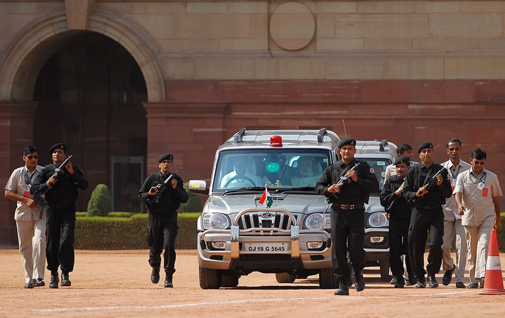 Narendra Modi arrives to address the media after meeting the Indian president, outside the Presidential Palace in New Delhi.