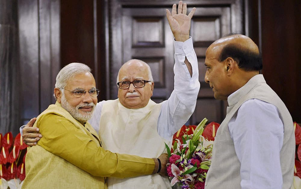 Narendra Modi hugs party leader Lal Krishna Advani, as party President Rajnath Singh watches during the BJP parliamentary party meeting in New Delhi.