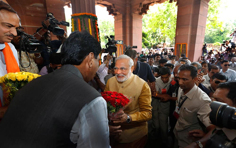 Narendra Modi is received with flowers as he arrives for the BJP parliamentary party meeting in New Delhi.