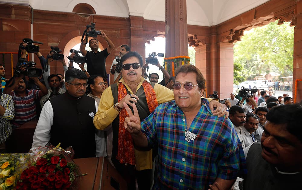 Shatrughan Sinha and Vinod Khanna pose for cameras as they arrive for the BJP parliamentary party meeting in New Delhi.