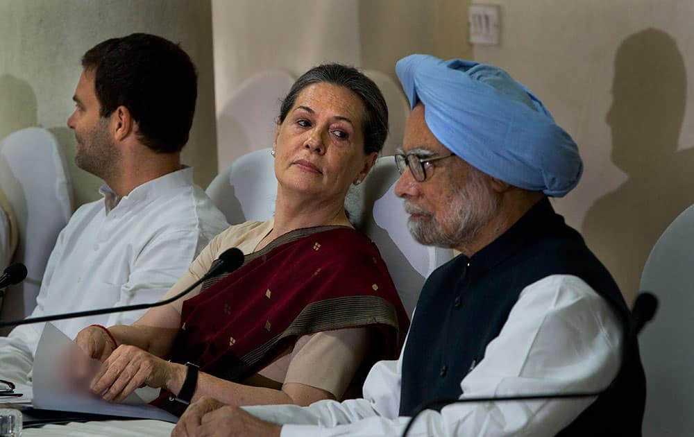 India’s outgoing prime minister Manmohan Singh, right, Congress party president Sonia Gandhi, center, and her son and party vice president Rahul Gandhi, attend a meeting of the Congress Working Committee to review the party’s defeat in the general elections in New Delhi.