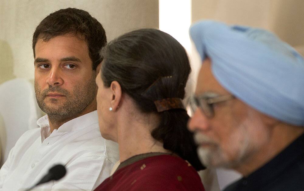 India’s outgoing prime minister Manmohan Singh, sits on the right as Congress party president Sonia Gandhi, center, talks to her son and party vice president Rahul Gandhi, left, during a meeting of the Congress Working Committee to review the party’s defeat in the general elections in New Delhi.