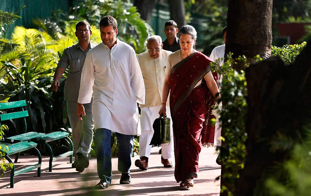 Congress party president Sonia Gandhi, front right, and her son and party vice president Rahul Gandhi, front left, arrive to attend a meeting of the Congress Working Committee to review the party’s defeat in the general elections in New Delhi.