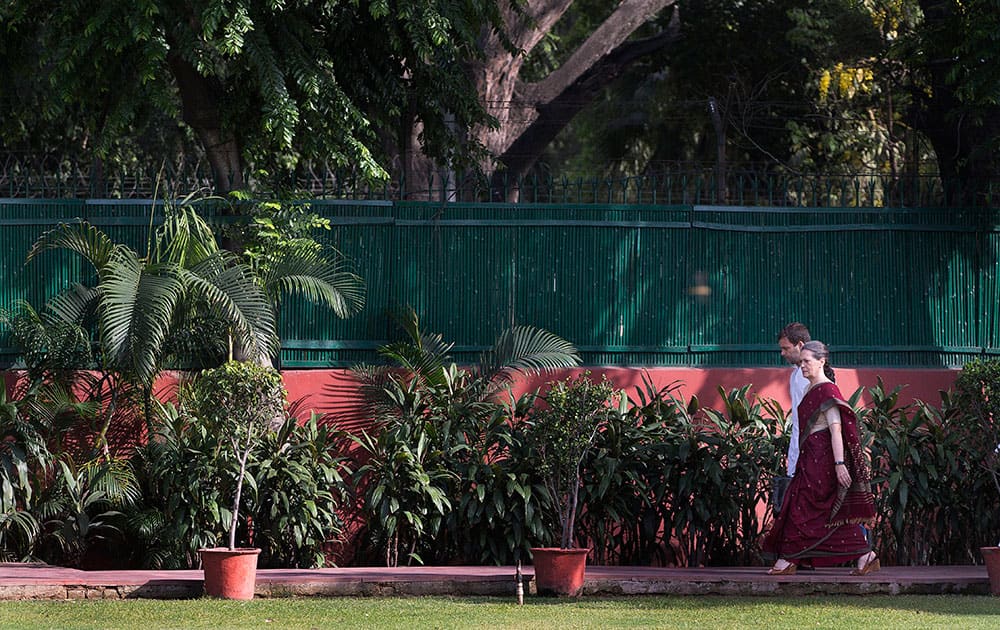 Congress party president Sonia Gandhi, front, and her son and party vice president Rahul Gandhi, arrive to attend a meeting of the Congress Working Committee to review the party’s defeat in the general elections in New Delhi.