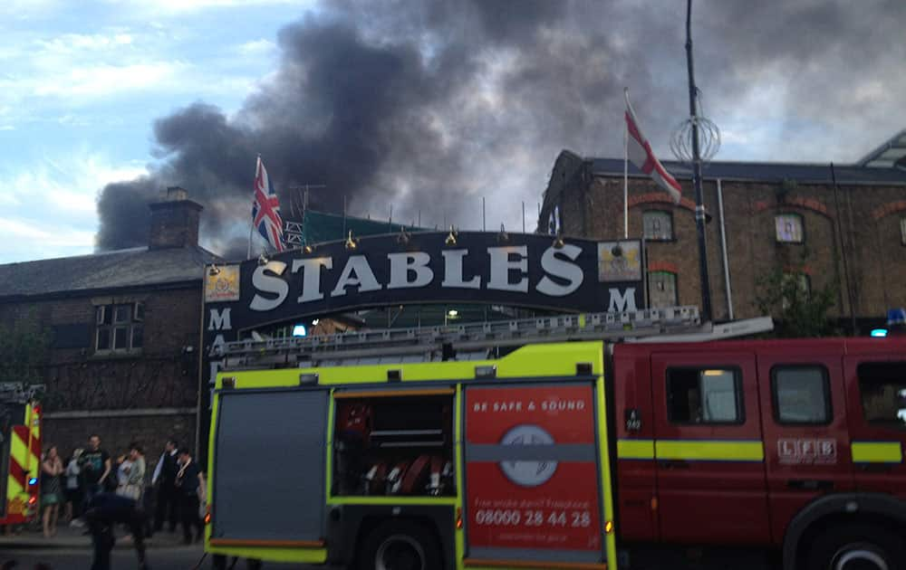 Smoke rises from the Stables Market area of Camden Town, central London. The area was evacuated by the fire services. 